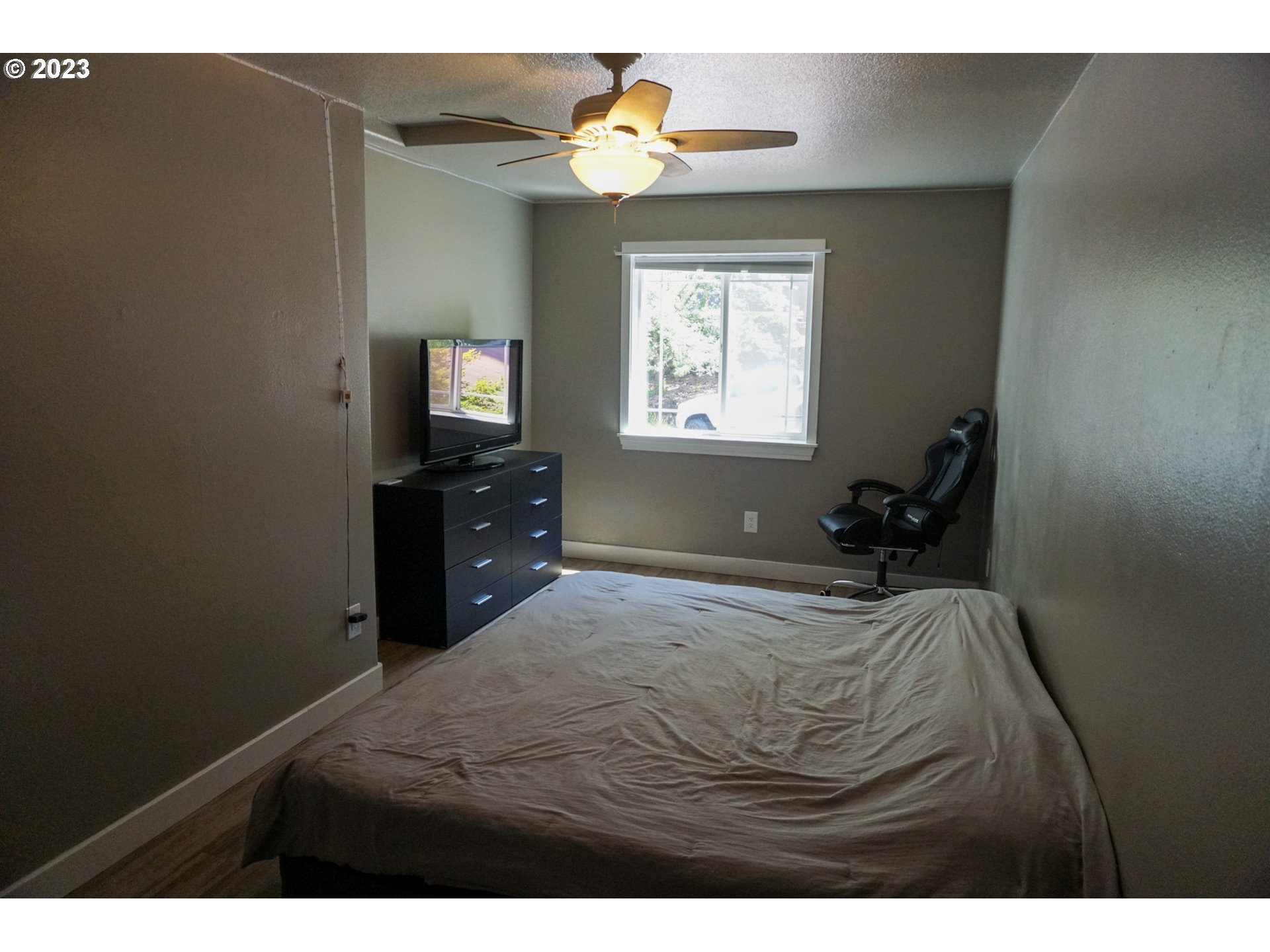 828 South 73rd Street Springfield, OR 97478 - Photo 16 of 23 a bedroom with a bed and a chandelier
