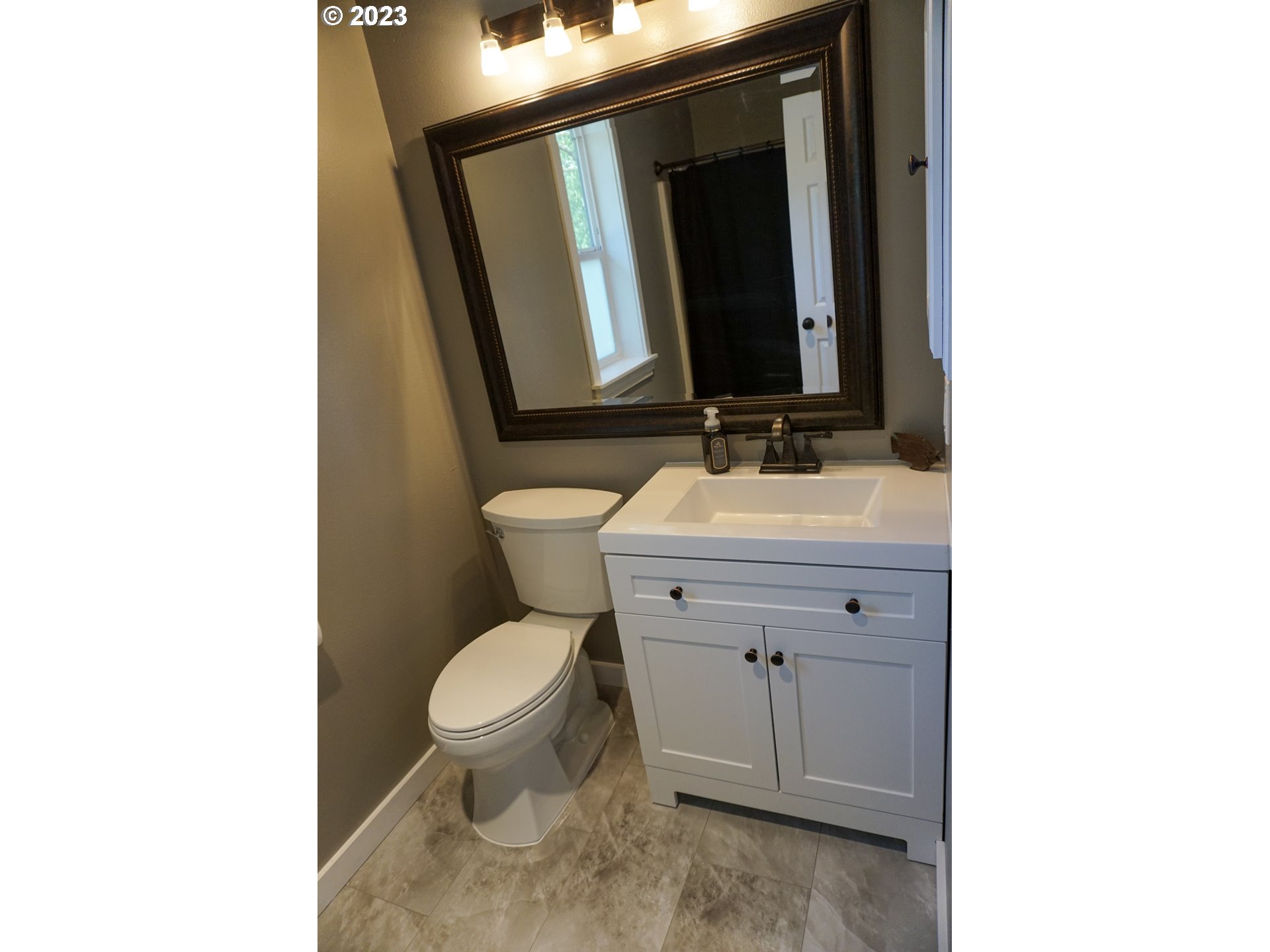 828 South 73rd Street Springfield, OR 97478 - Photo 18 of 23 a bathroom with a toilet sink and mirror