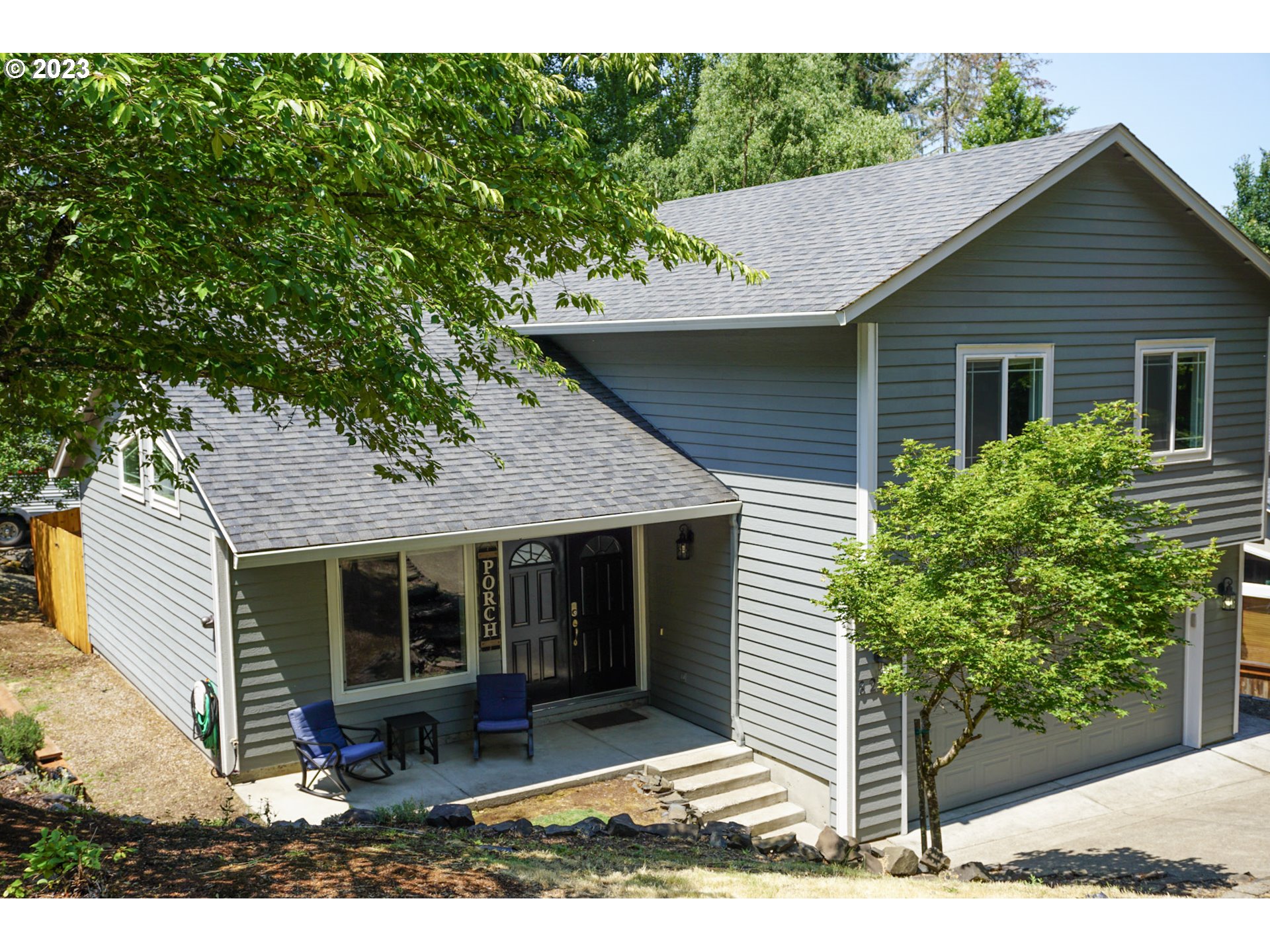 828 South 73rd Street Springfield, OR 97478 - Photo 3 of 23 a view of a house with a yard plants and large tree
