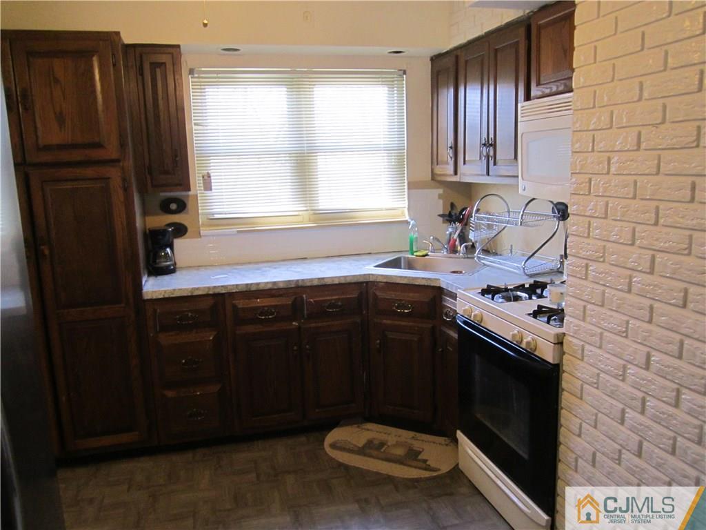 26 Outcalt Road Edison, NJ 08817 - Photo 7 of 23 a kitchen with a stove and a refrigerator