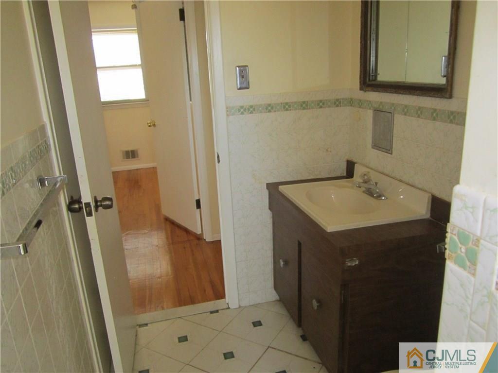 26 Outcalt Road Edison, NJ 08817 - Photo 10 of 23 a bathroom with a sink a mirror and a shower