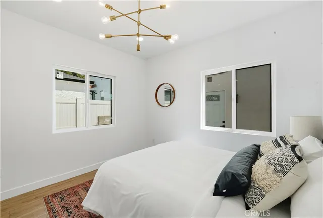 a bedroom with a bed and a chandelier