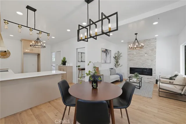 a view of a dining room with furniture wooden floor and chandelier