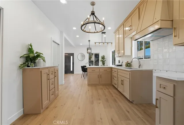 a kitchen with cabinets a sink and appliances