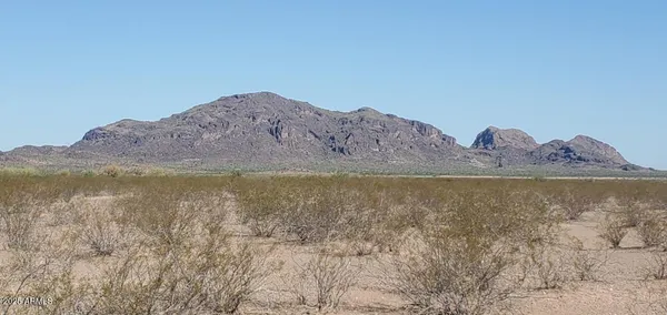 a view of a large body of water with a mountain in the background