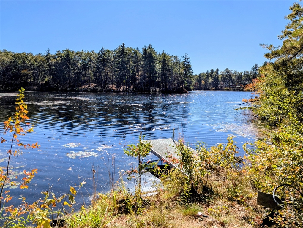 34 Hallock Point Road Stow, MA 01775 - Photo 3 of 5 a view of a lake with sitting area