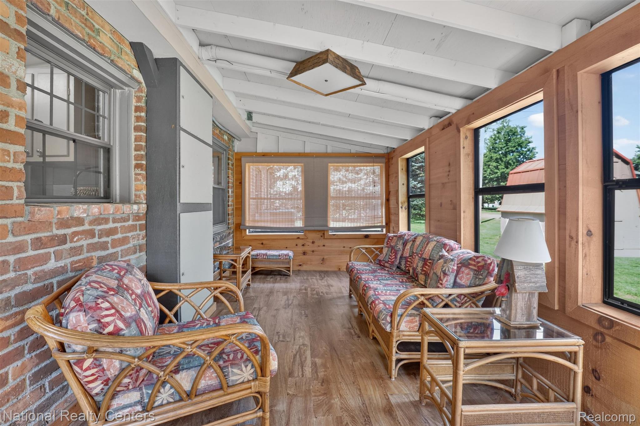 127 West Albain Road Petersburg, MI 49270 - Photo 46 of 61 Enclosed porch with exposed brick wall and multiple windows