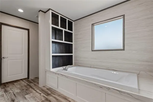 a bathroom with a bathtub and a window