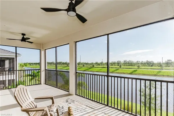 a balcony view with a couch and a floor to ceiling window