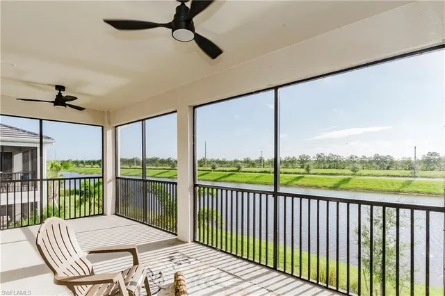 a balcony view with a couch and a floor to ceiling window