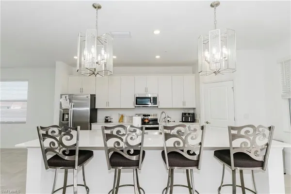 a view of a dining room with furniture a chandelier and chandelier