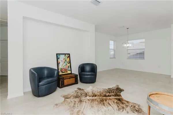 a bedroom with a couch and a chair