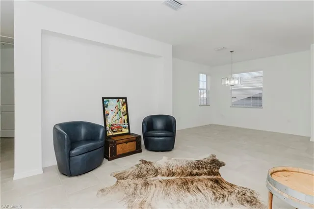 a bedroom with a couch and a chair