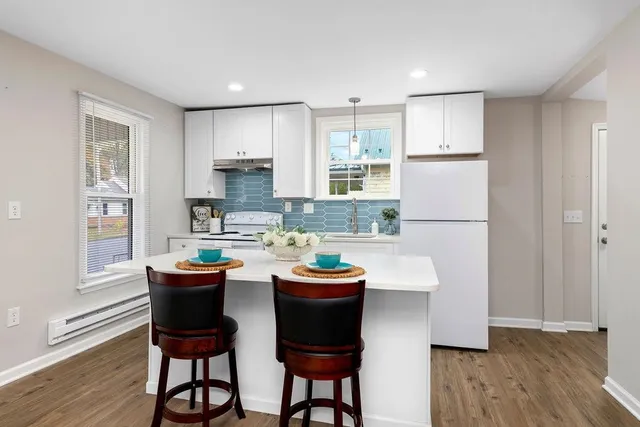 a kitchen with dining table and chairs