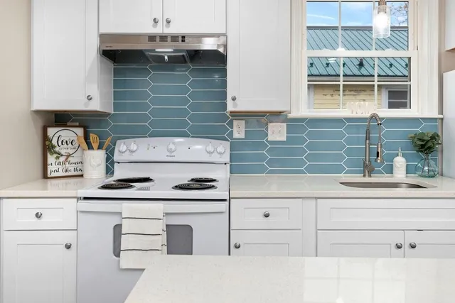a kitchen with a sink and cabinets