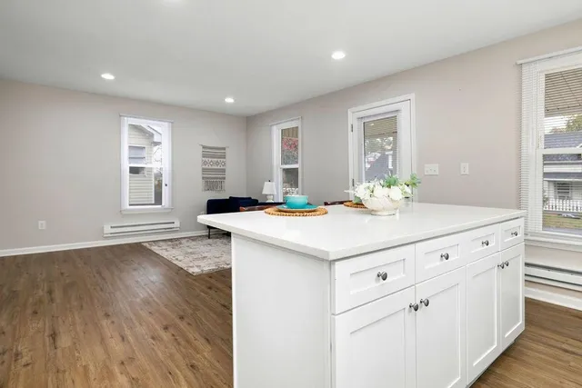 a kitchen with granite countertop white cabinets and white appliances