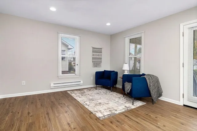 a living room with hard wood floors and a window