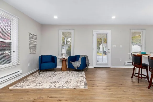 a living room with furniture rug and window