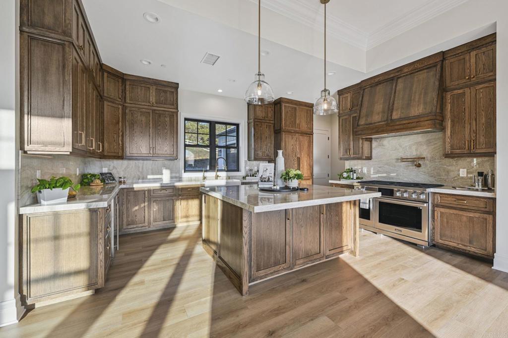 662 Lower Springs Road Fallbrook, CA 92028 - Photo 11 of 72 a kitchen with stainless steel appliances kitchen island granite countertop a stove a sink and a refrigerator