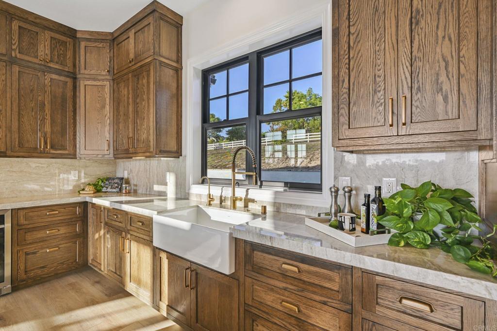 662 Lower Springs Road Fallbrook, CA 92028 - Photo 13 of 72 a kitchen with stainless steel appliances granite countertop a sink a stove and a wooden cabinets