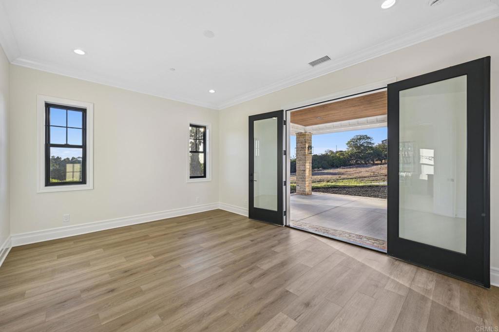 662 Lower Springs Road Fallbrook, CA 92028 - Photo 18 of 72 a view of an empty room with glass door and a window