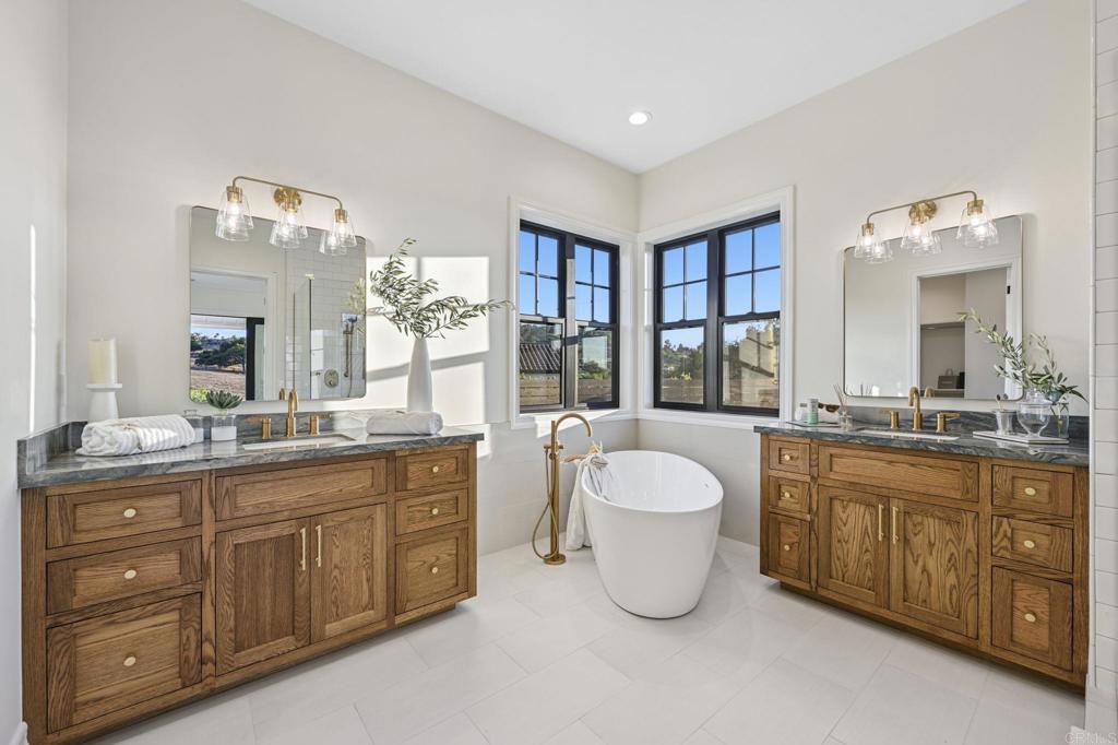 662 Lower Springs Road Fallbrook, CA 92028 - Photo 20 of 72 a spacious bathroom with a granite countertop double vanity sink a mirror and a bathtub