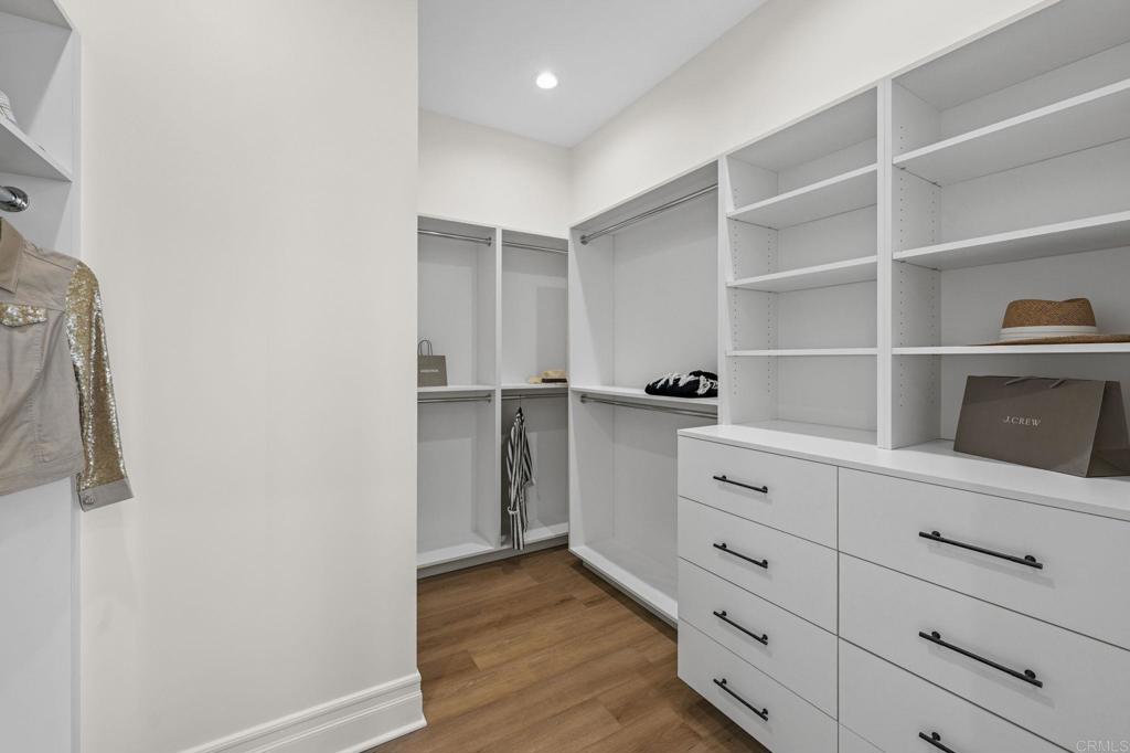 662 Lower Springs Road Fallbrook, CA 92028 - Photo 23 of 72 a hallway with white cabinets and wooden floor