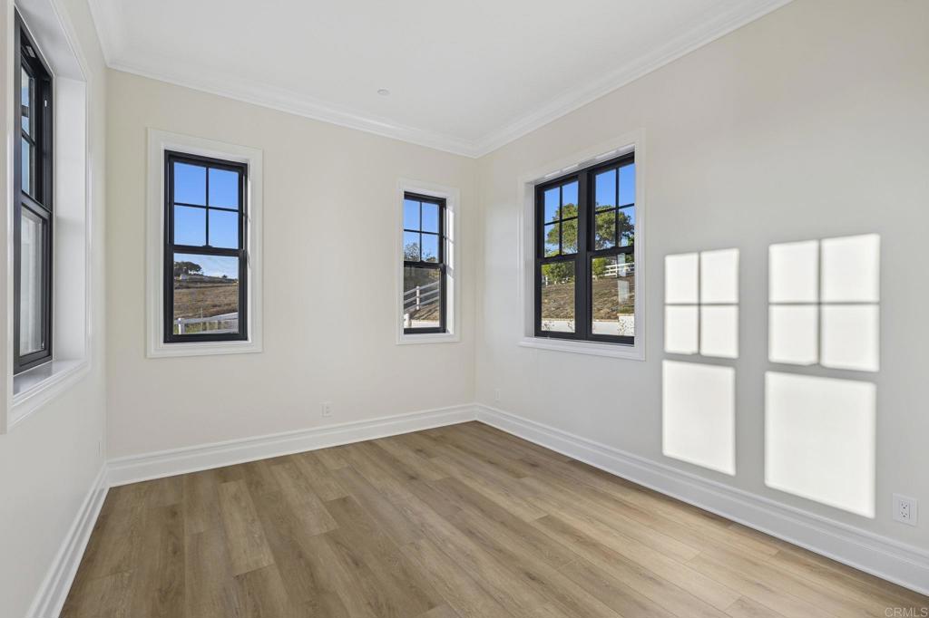 662 Lower Springs Road Fallbrook, CA 92028 - Photo 24 of 72 a view of an empty room with wooden floor and a window