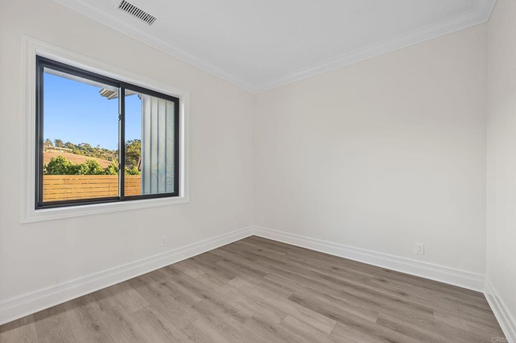 662 Lower Springs Road Fallbrook, CA 92028 - Photo 29 of 72 a view of an empty room with wooden floor and a window