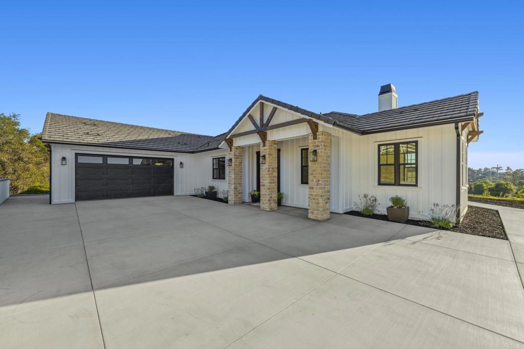 662 Lower Springs Road Fallbrook, CA 92028 - Photo 56 of 72 a front view of a house with a yard and garage