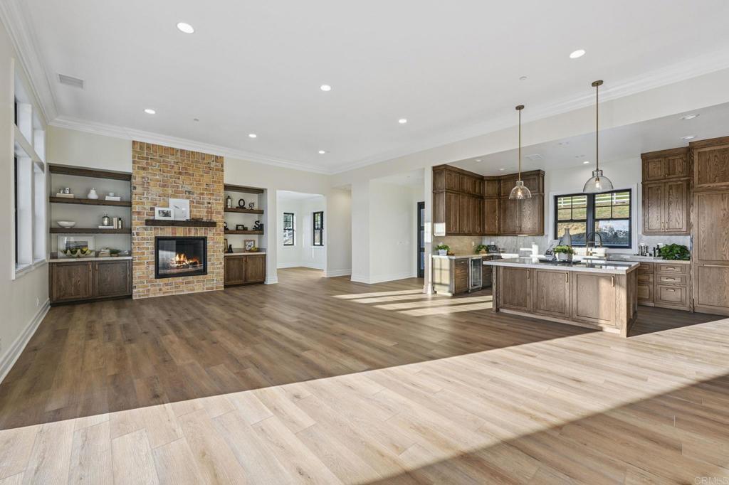 662 Lower Springs Road Fallbrook, CA 92028 - Photo 9 of 72 a large kitchen with stainless steel appliances kitchen island granite countertop a refrigerator a stove a sink and a wooden floor