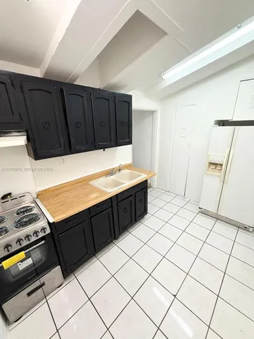 a room with a bed and a stove top oven