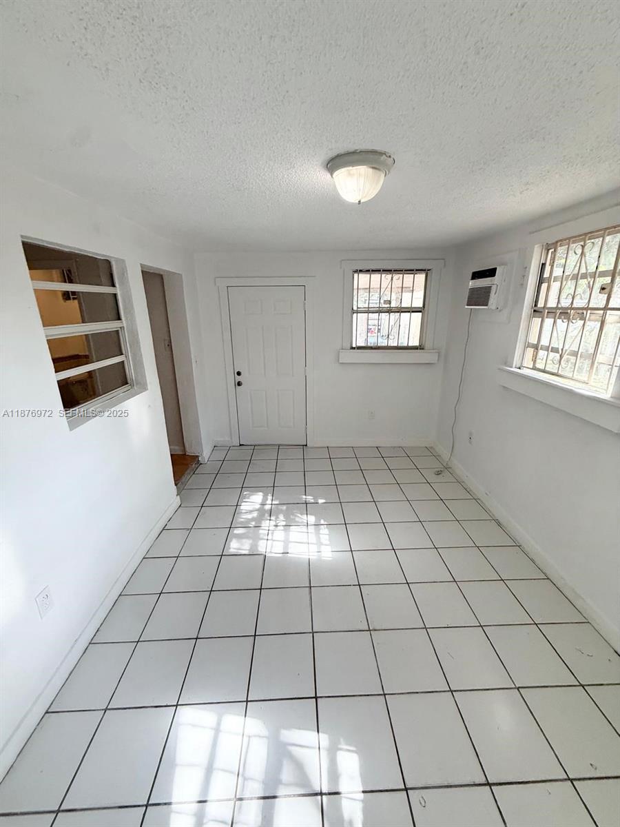 1340 Peri Street, Unit D Opa-Locka, FL 33054 - Photo 3 of 6 a view of an empty room and window