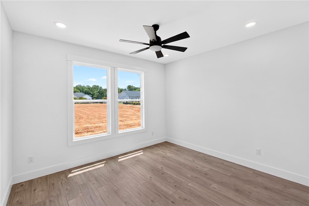 424 Blume Road Anderson, SC 29625 - Photo 24 of 30 A well-lit interior space features sleek wood flooring and ample natural illumination.