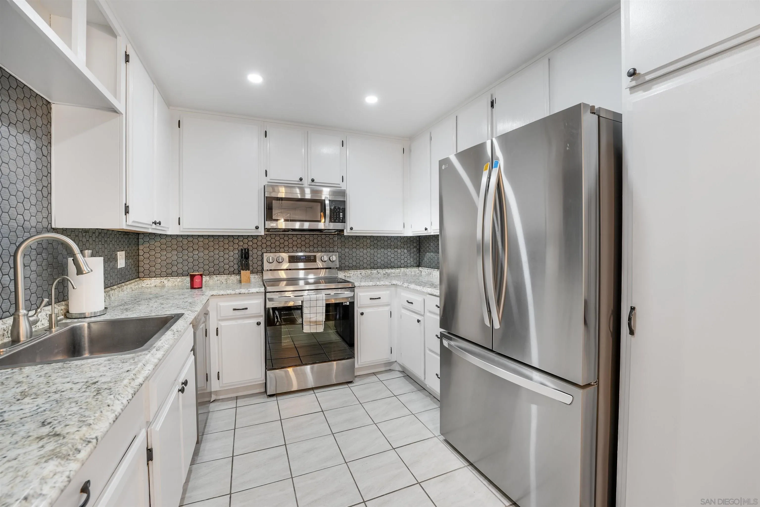 6747 Friars Road, Unit 113 San Diego, CA 92108 - Photo 12 of 48 a kitchen with stainless steel appliances granite countertop a refrigerator sink and stove