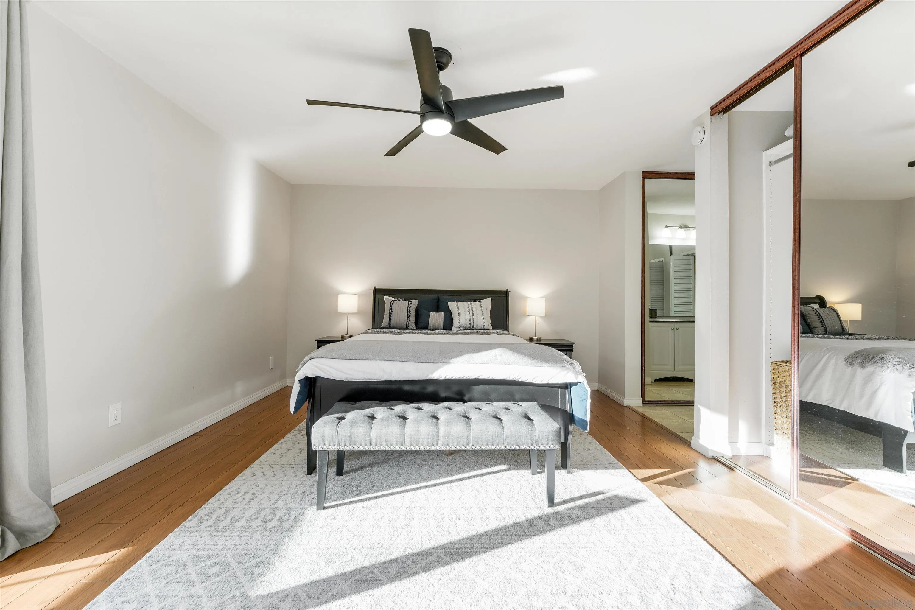 6747 Friars Road, Unit 113 San Diego, CA 92108 - Photo 27 of 48 a bedroom with a bed and a mirror