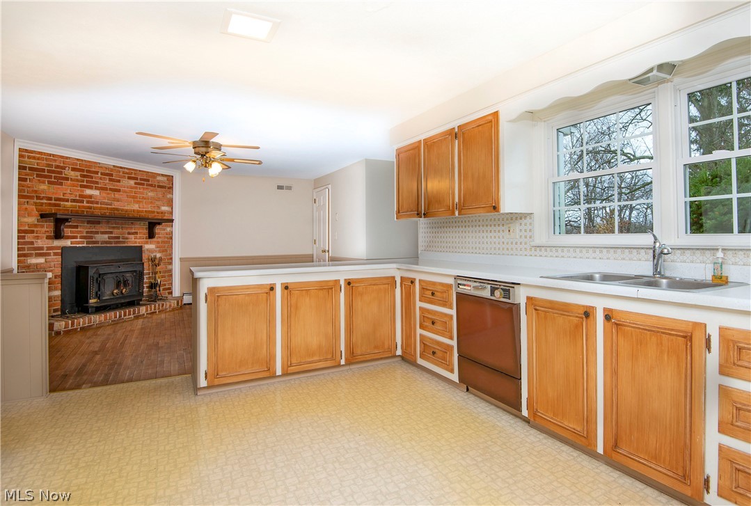 The exceptionally sized  kitchen is open to the family room and has wood cabinets that could easily be painted for a quick new look.   Kitchen sink window looks out to the private deep back yard.