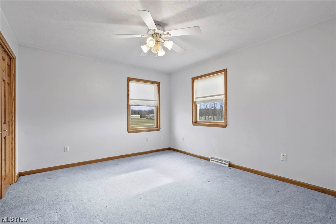 411 Adario West Road Shiloh, OH 44878 - Photo 21 of 35 Carpeted empty room with ceiling fan