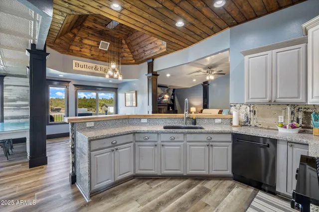 a kitchen with stainless steel appliances granite countertop a stove and white cabinets