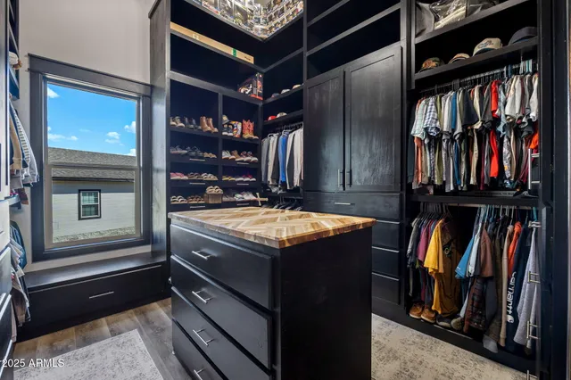 a bedroom with a bed a couch and a flat screen tv