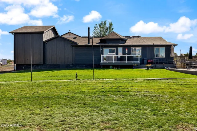 a bathroom with a sink a mirror a vanity and a shower