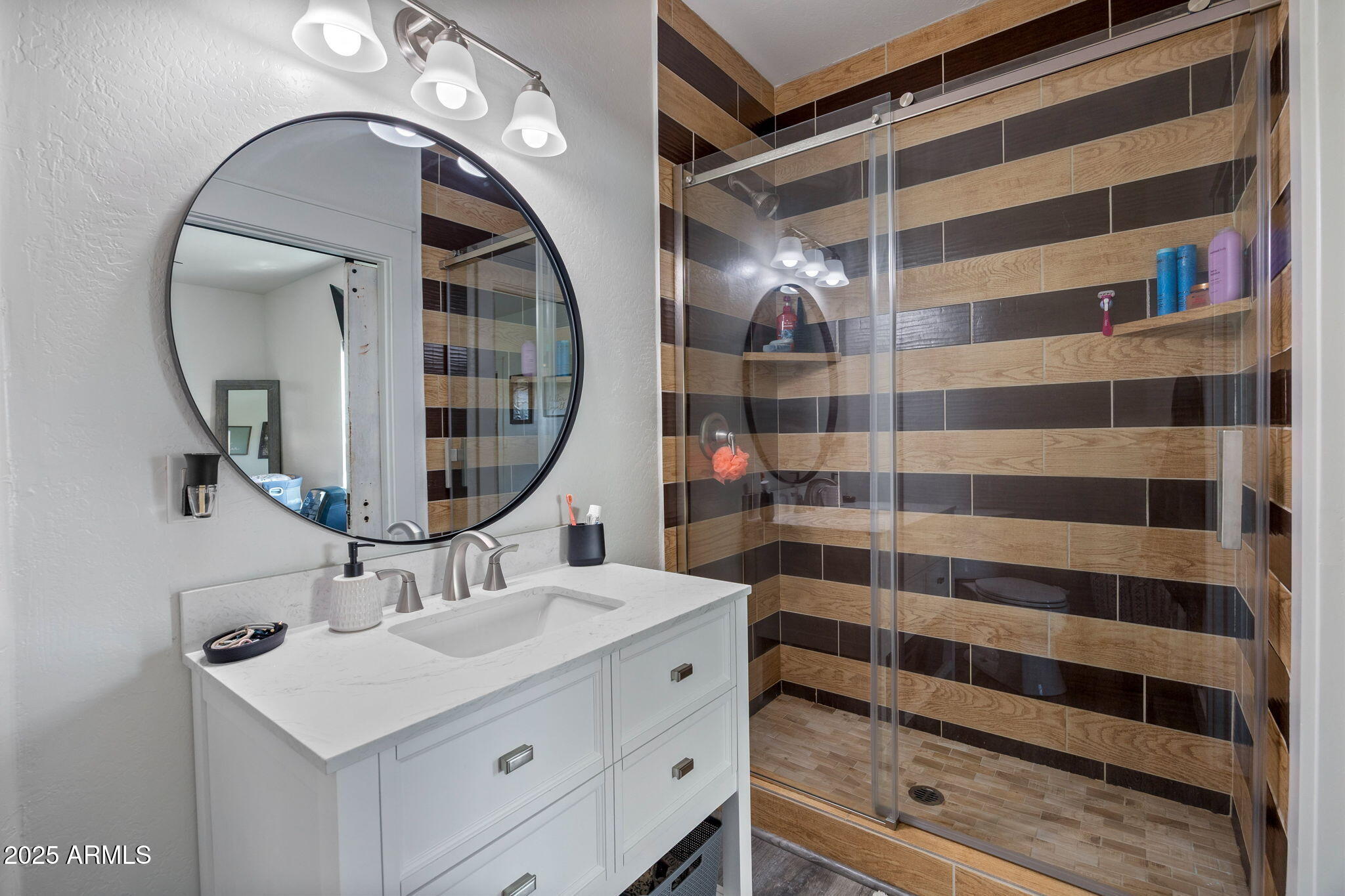 7106 Long Road Show Low, AZ 85901 - Photo 47 of 65 a bathroom with a sink a mirror a vanity and a shower