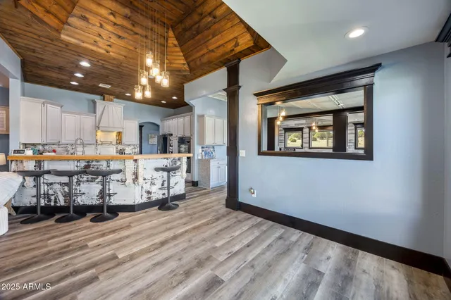 a large kitchen with lots of counter space a sink appliances and dining table