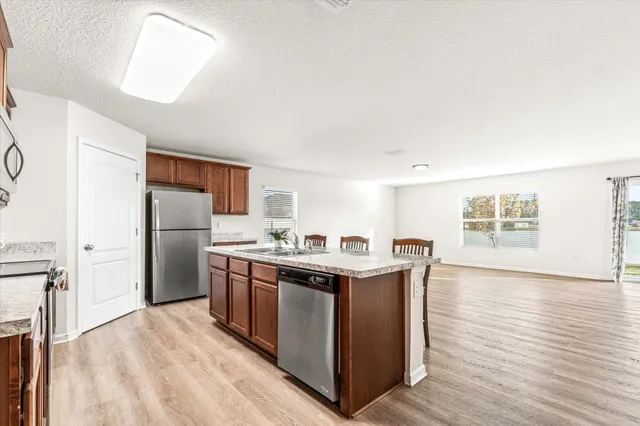 a kitchen with stainless steel appliances granite countertop a stove and a refrigerator