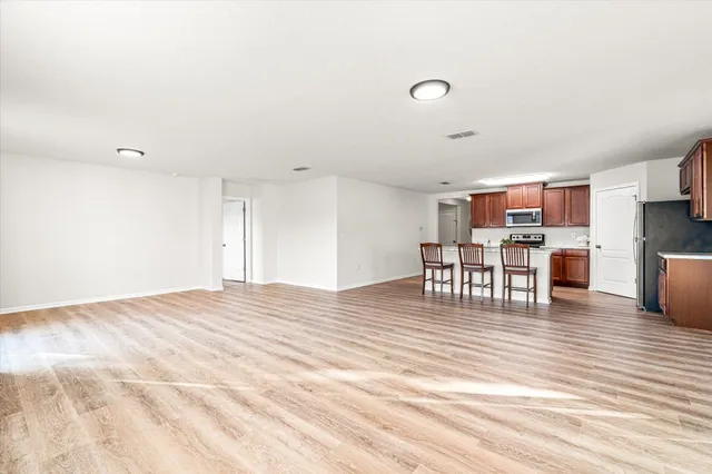 a view of dining room kitchen with furniture and wooden floor