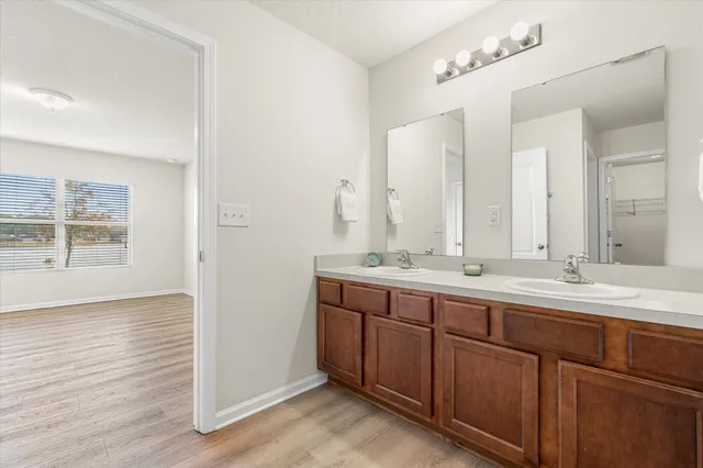 a bathroom with a double vanity sink and a mirror