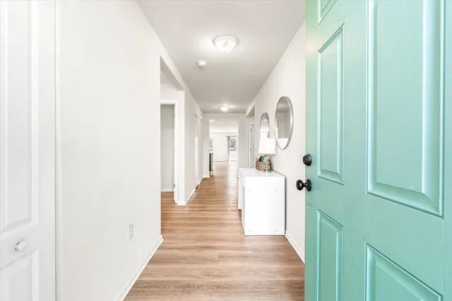 a view of a hallway with wooden floor