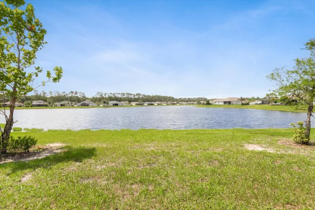 a aerial view of a pool patio and lake view