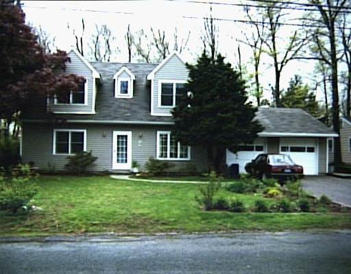 484 Davis Road Fairfield, CT 06825 - Photo 1 of 1 a front view of a house with a garden