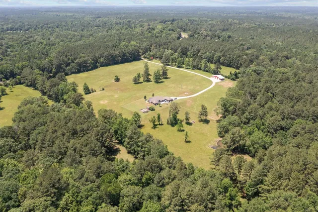 a front view of house with swimming pool and porch with furniture